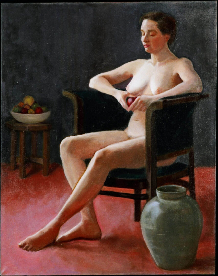 Nude woman in chair with apple