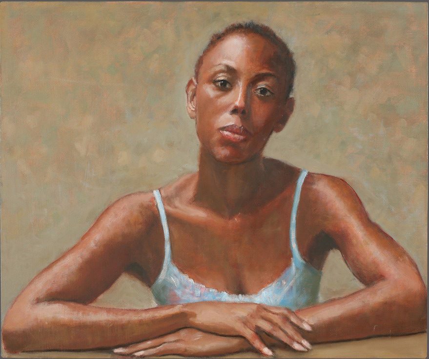 Woman in blue top, contemplative pose