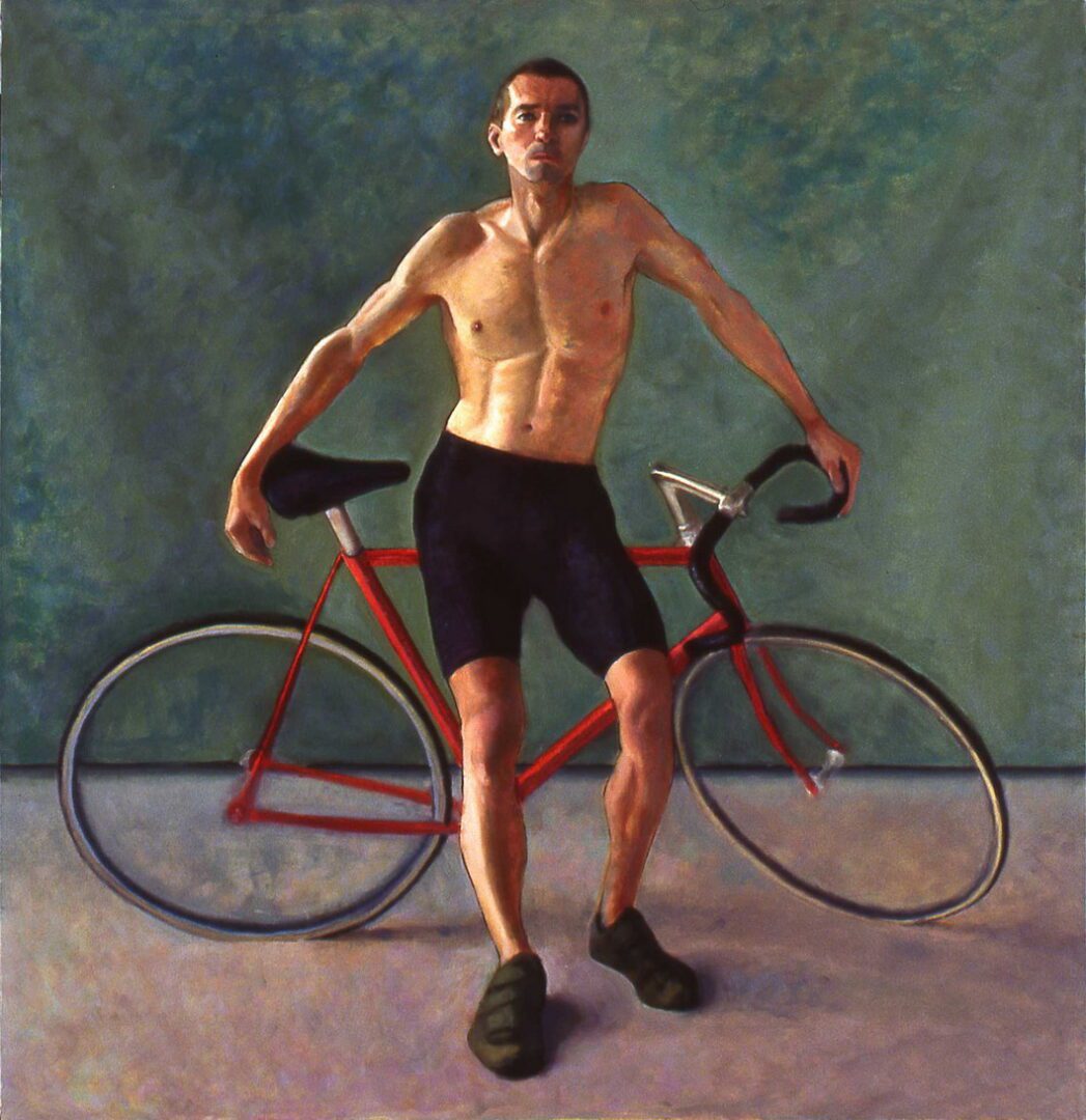 Man posing with red bicycle