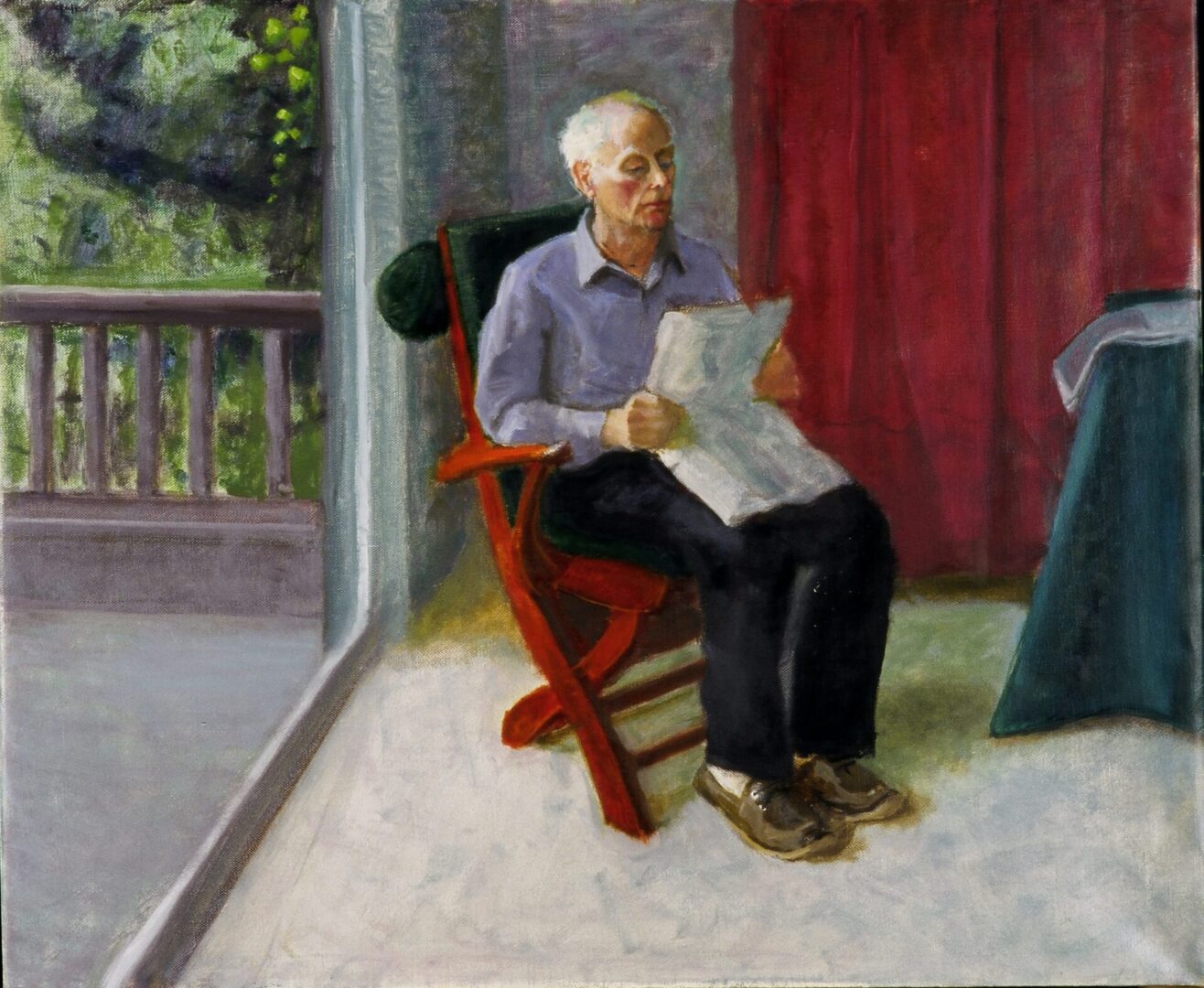 Elderly man in a chair with newspaper