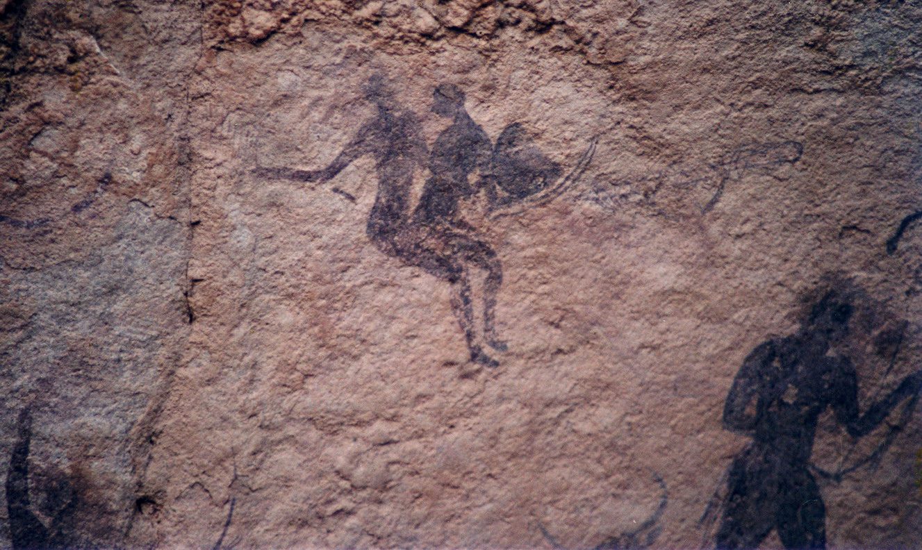 Prehistoric cave painting of hunters